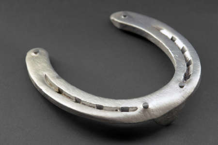 horseshoe closeup in dark backの写真素材