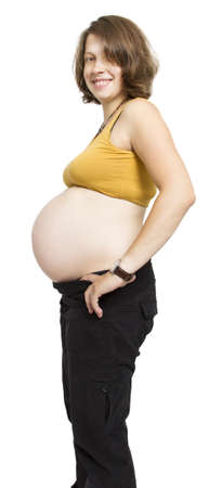 pregnant young woman  with naked belly in white backgroundの写真素材
