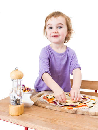 cute girl making pizza with a smile  isolated on white backgroundの写真素材