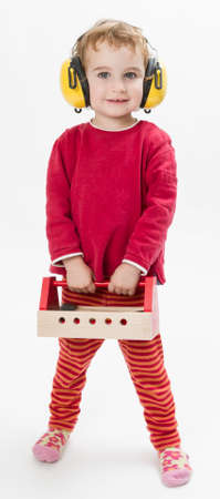 child in red clothing with toolbox and earmuffs  vertical imageの写真素材
