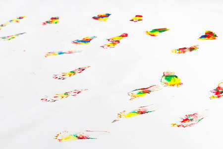 many colorful footprints of small child on floorの写真素材