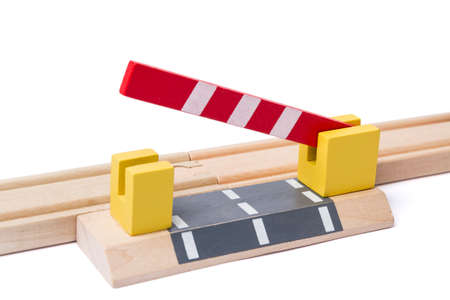 barrier is opening to give way over wooden railroad trackの写真素材