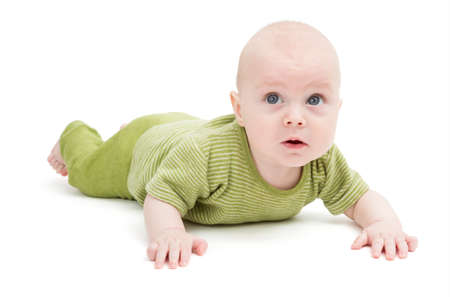 crawling baby in green romper suit isolated on white background  studio shotの写真素材