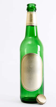 empty green beer bottle with crown seal in light backgroundの写真素材