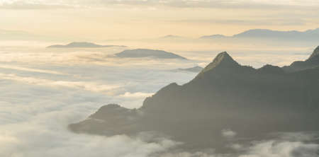 A view from hill of North Thailand in morning february and sunlight emanate on clouds flowの写真素材
