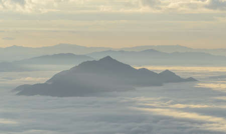 A view from hill of North Thailand in morning february and sunlight emanate on clouds flowの写真素材