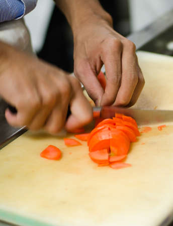 Chef cutting carrot prepare food in restaurant,Hand cutting vegetable fast it's skillの写真素材