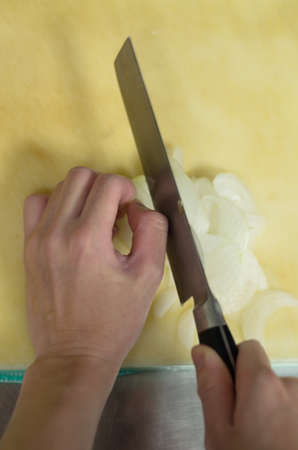 Chef cutting onion prepare food in restaurant,Hand cutting vegetable fast it's skillの写真素材