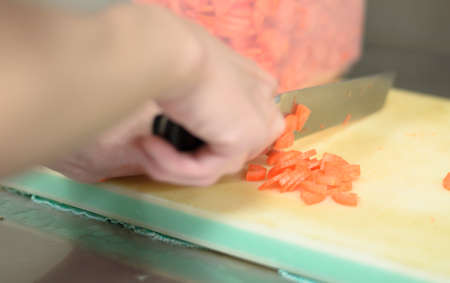 Chef cutting carrot prepare food in restaurant,Hand cutting vegetable fast it's skillの写真素材