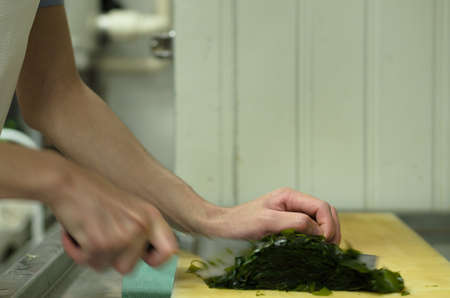 Chef cutting seaweed prepare food in restaurant,Hand cutting vegetable fast it's skillの写真素材
