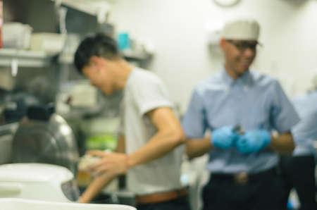 Blurred restaurant kitchen,Chef cooking food and preparing in japan shop
