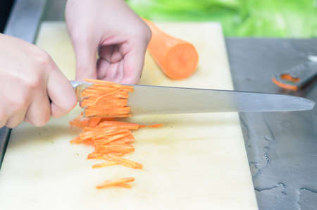 Chef cutting carrot with skillfully and cutting fastの写真素材
