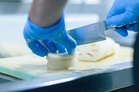 Chef cutting lotus root with skillfully and cutting fastの写真素材