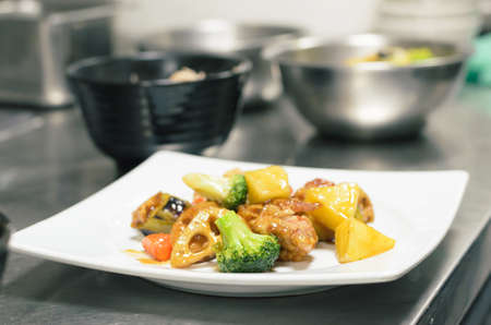 Chicken and vegetable intermix in vinegar sauce  put on white plateの写真素材