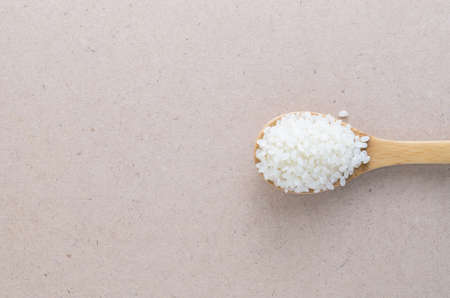Top view rice in wooden spoon on backgroundの写真素材