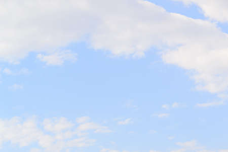 White fluffy clouds in  blue sky and copyspace for backgroundsの写真素材