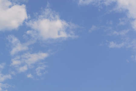 White fluffy clouds in  blue sky and copyspace for backgroundsの写真素材