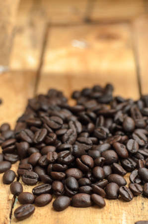 roasted coffee beans on wooden tableの写真素材
