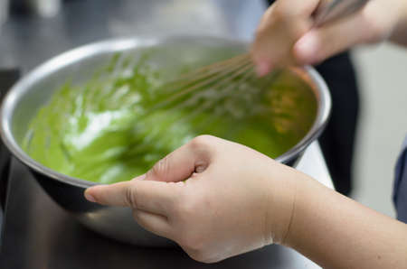chef mix green tea cream in bowlの写真素材
