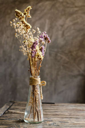 dried flower in vase on table and backdropの写真素材