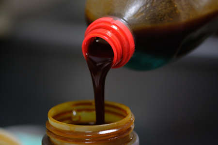 Pouring soy sauce into a bottleの写真素材