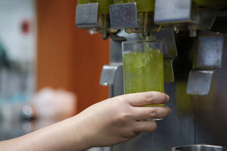 Hands hold glass insert green tea