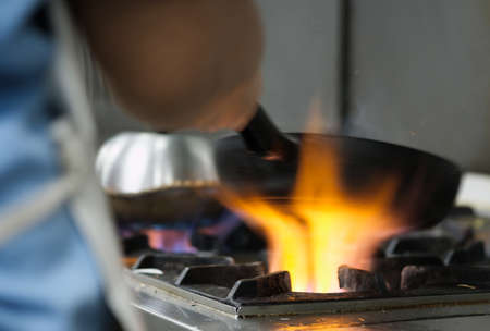 Chef use pan on gas stoveの写真素材