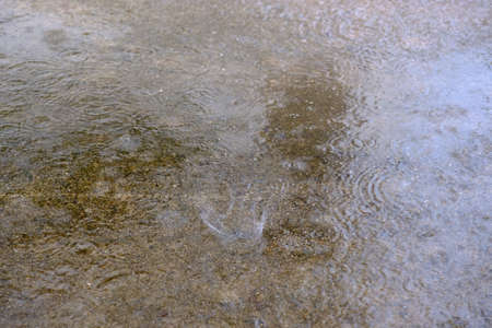 Rain drop on to the ground,rebound upの写真素材