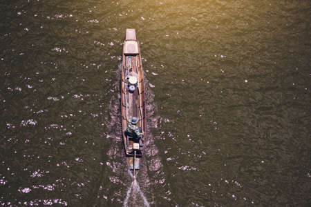 The  fisherman drive long tail boat in the lake ,insert color effect toneの写真素材