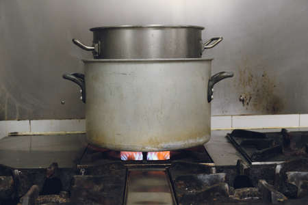 boiling water in pot on gas stoveの写真素材