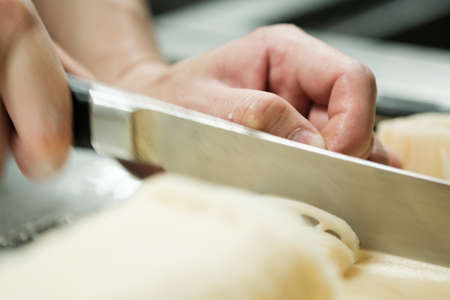 Chef training cut vegetable on cutting board with knife japanの写真素材