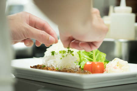 Hands chef preparing food on tableの写真素材