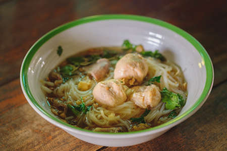 Noodle and soup in bowl put on the tablの写真素材