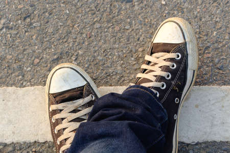 Foot and shoes on groundの写真素材