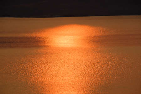 Light of sunset and sunrise reflection in waterの写真素材