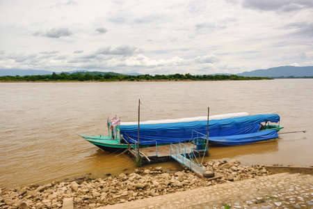 Long tail boat moored at the MEKHONG Riverの写真素材