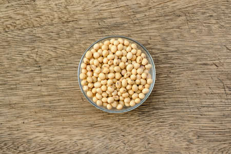 Soybeans are in a cup, placed on a wooden table