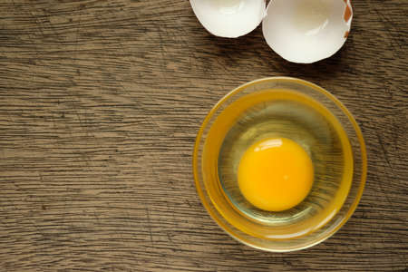 Eggs in a cup Lay on the wooden background and copy spaceの写真素材