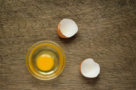 Eggs in a cup Lay on the wooden background and copy spaceの写真素材