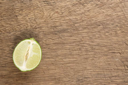 Fresh half lime on wooden board and copy spaceの写真素材