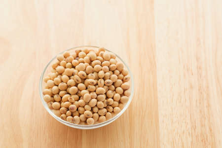 Soybeans are in a cup, placed on a wooden table with copy spaceの写真素材