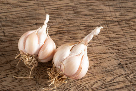 Garlic placed on a wooden tableの写真素材