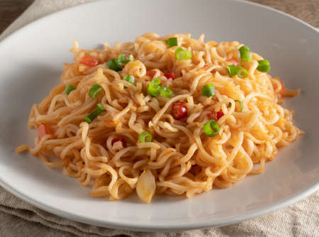 The noodles are in a round white plateの写真素材