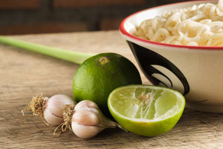 Close up lime and garlic on wooden board