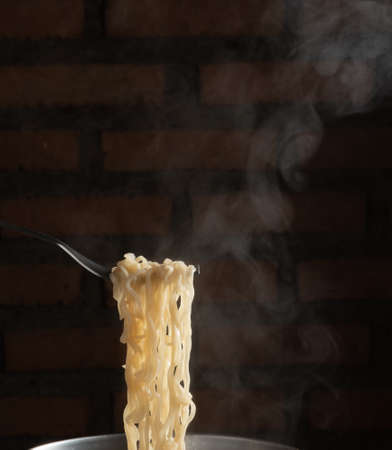 Fork for instant hot noodles in pot. steam noodleの写真素材