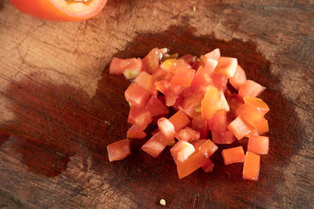 Some fresh Diced Tomatoes on cutting boardの写真素材