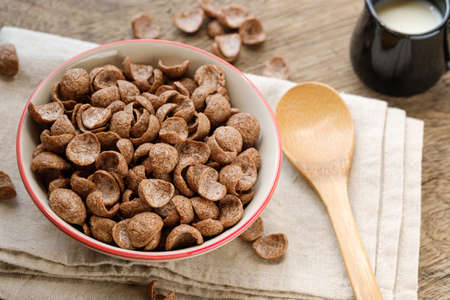 Cereals breakfast cocoa flavor in bowl on wooden backdropの写真素材