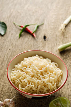 A cup of instant noodles placed on a wooden tableの写真素材