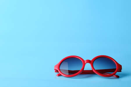 Red glasses on blue  background with copy spaceの写真素材