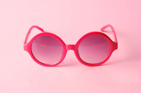 Red glasses on pink  background with copy spaceの写真素材